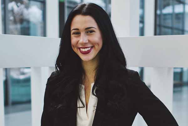 student in professional suit smiling in portrait