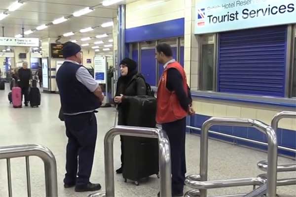 Mona Minkara talks to employees at British transportation station.