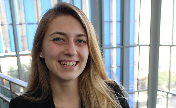 female student smiling shown from shoulders up